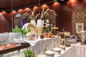 a buffet with fruits and vegetables on a table at Novum Hotel Continental Frankfurt in Frankfurt