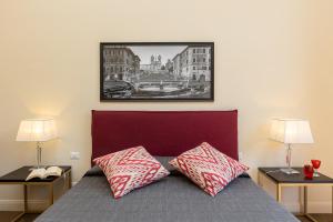 a bedroom with a bed with two tables and two lamps at SPA Apartment Via Barberini in Rome