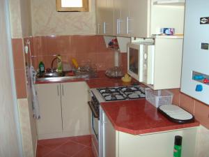 A kitchen or kitchenette at Marcsi Apartman