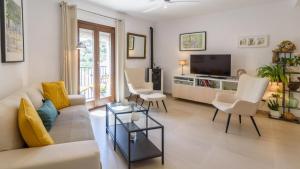 a living room with a couch and chairs and a tv at Casa Antana Frigiliana by Ruralidays in Frigiliana