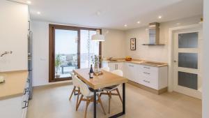 a kitchen with a table and chairs and a window at Casa Antana Frigiliana by Ruralidays in Frigiliana