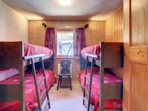 a room with three bunk beds and a window at Emeraude 319 in Verbier
