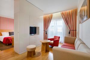 a living room with a couch and a bed at Mamaison Hotel Riverside Prague in Prague