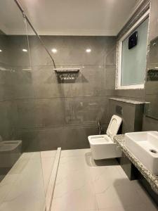 a bathroom with a shower and a toilet and a sink at The Empire - Signature Tower,Cyber City, Gurgaon in Gurgaon