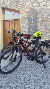 a bike parked in front of a building with a helmet at Agriturismo Gradec in Aurisina