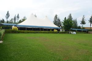 a tent in the middle of a grass field at Silent Hill Hotel Kayonza in Kayonza