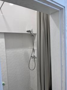 a shower in a bathroom with a shower curtain at Oldtown apartment in Vilnius