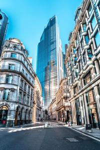 an empty street in a city with tall buildings at Stay Thames River in London
