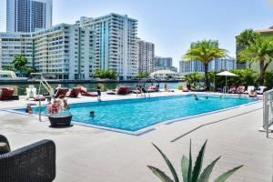 a swimming pool in a city with buildings at 1 BD 1 BA @Beachwalk Resort in Hallandale Beach