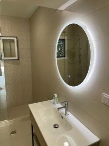 a bathroom with a sink and a mirror at Diacopto Country Houses in Diakopto