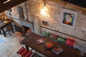 a living room with a table and a fireplace at Anemi in Káto Pediná
