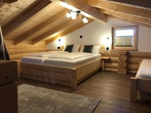 a bedroom with a large bed in the attic at Biohof Weiderer in Lindberg