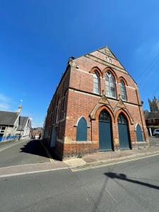 a red brick building on the side of a street at Church Mews in Exmouth