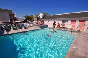 a large swimming pool with people in the water at Riviera Resort & Suites in Wildwood