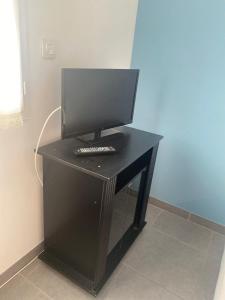 a black desk with a computer on top of it at Chambres d'hôtes Drome in Chatuzange-le-Goubet