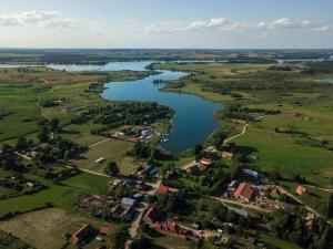 an aerial view of a river and a village at Czerwony domek nad samym jeziorem in Mikołajki