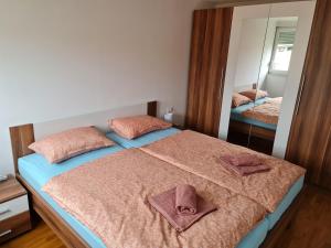 a bedroom with a bed with two towels on it at Apartman BELAMAR in Duga Resa