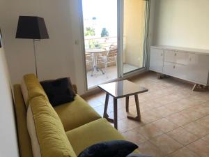 a living room with a couch and a table at Citronnier Monaco Sea View in Beausoleil