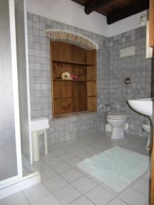 a bathroom with a toilet and a sink at Agriturismo Al Col in Follina +16 photos