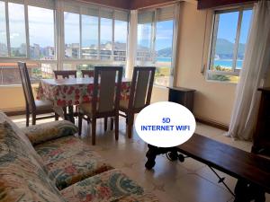 a living room with a table and a couch and a table and chairs at Apartment Laredo Sea Beach in Laredo