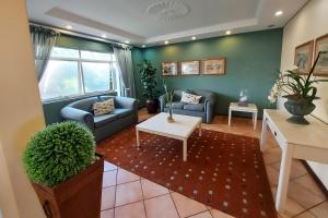 a living room with a couch and a table at First Group Brookes Hill Suites in Summerstrand