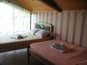 a bedroom with two beds and a window at Guest House Slivek in Slivek