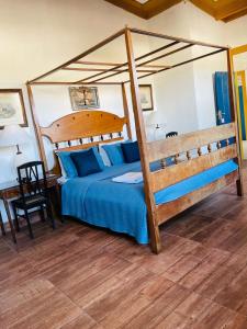 a bedroom with a bed with a surfboard on it at Suítes Casa da Colônia in Paraty