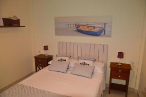 a bedroom with a bed and a boat on the wall at Apartamento en Casco Histórico in San Sebastián de la Gomera