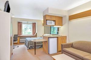 a small room with a kitchen and a living room at Days Inn by Wyndham Sturbridge in Sturbridge