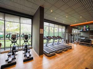 a gym with a row of treadmills and elliptical machines at Amazing One Bedroom Apartment Space Available in Accra