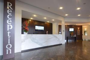 a lobby with a large marble counter in a building at Rydges South Park Adelaide in Adelaide