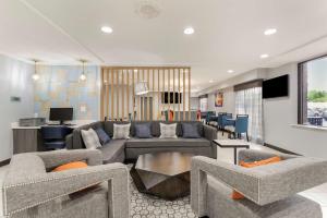 a living room with a couch and chairs and a table at Best Western Plus Magnolia Inn & Suites in Cleveland