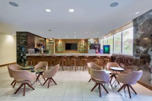 a lobby with a bar with chairs and a counter at TRYP by Wyndham Manaus in Manaus