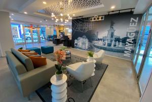 a lobby with a couch and chairs and a table at TRYP by Wyndham Mayaguez in Mayaguez