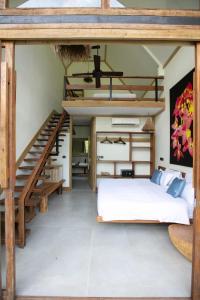 a bedroom with a bed and a staircase at Satya Boutique Resort & Spa in Havelock Island