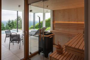 a house with a balcony with a table and chairs at steiRerBLiCke - Domizil Vochera am Weinberg mit Pool in Vochera am Weinberg