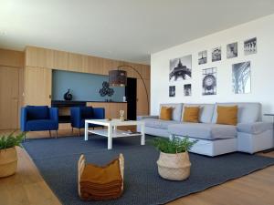 a living room with a white couch and a table at "Villa Carpe Diem" Country house in Cambarinho