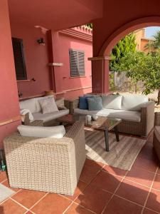 an outdoor patio with couches and a table at Holiday home HDA Golf Resort - HK 0011 B - Villa con picina privada in Fuente Alamo