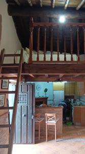 a room with a bunk bed and a kitchen at Casa rural TIO PEDRITO in Robledillo