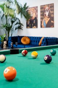 a pool table with balls on top of it at PAME Wild in Athens