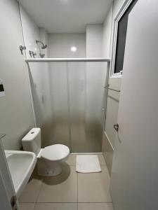 a white bathroom with a shower and a toilet at Hotel Catarina in São Miguel dʼOeste +28 photos