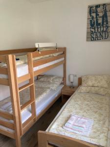 a bedroom with two bunk beds and a bed at Balati Vendégház in Balatonmáriafürdő