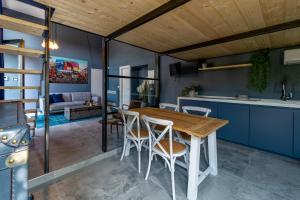 a kitchen and dining room with a wooden table and chairs at 147MqSuite in Santarcangelo di Romagna