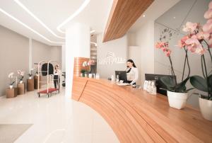 a woman sitting at a counter in a salon at Yacht Hotel in Vlorë