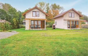 a house in a yard with a grass field at Awesome Home In Swinoujscie With 2 Bedrooms, Wifi And Outdoor Swimming Pool in Świnoujście