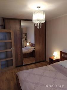 a bedroom with a large mirror and a bed at Fantastic By The Sea Apartment Set Up With Love in Gdańsk