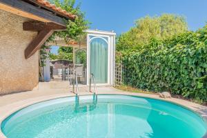 a swimming pool in front of a house at MAISON COSY avec petite piscine in Six-Fours-les-Plages