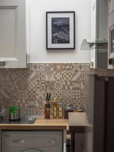 a kitchen with a counter with a picture on the wall at Alloggio del Vicolo - Le Vecchie Vasche in Coppito