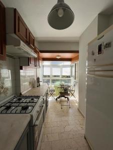 a kitchen with a stove and a table in a room at Green Garden View Apartment Near Zorlu Center in Istanbul