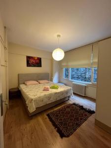 ein Schlafzimmer mit einem Bett und einem großen Fenster in der Unterkunft Green Garden View Apartment Near Zorlu Center in Istanbul